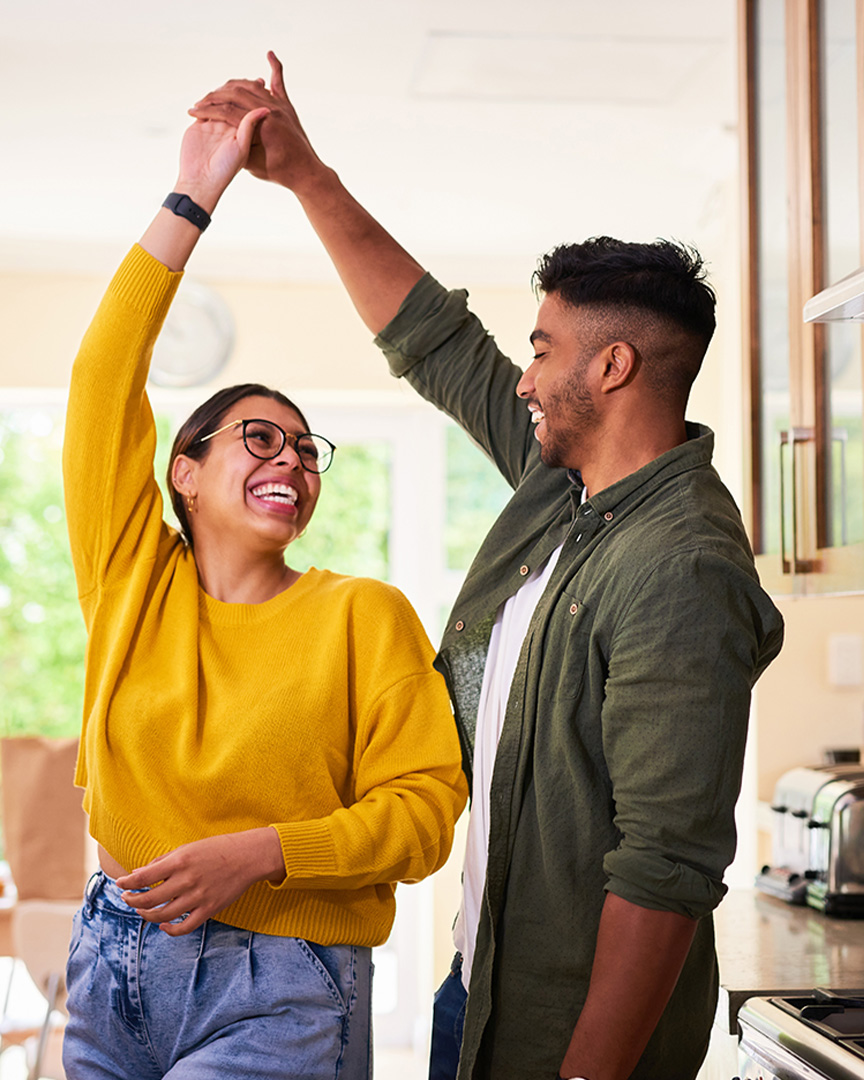 An international couple celebrating a new home from a Securities Secured Loan from Amerant Bank.