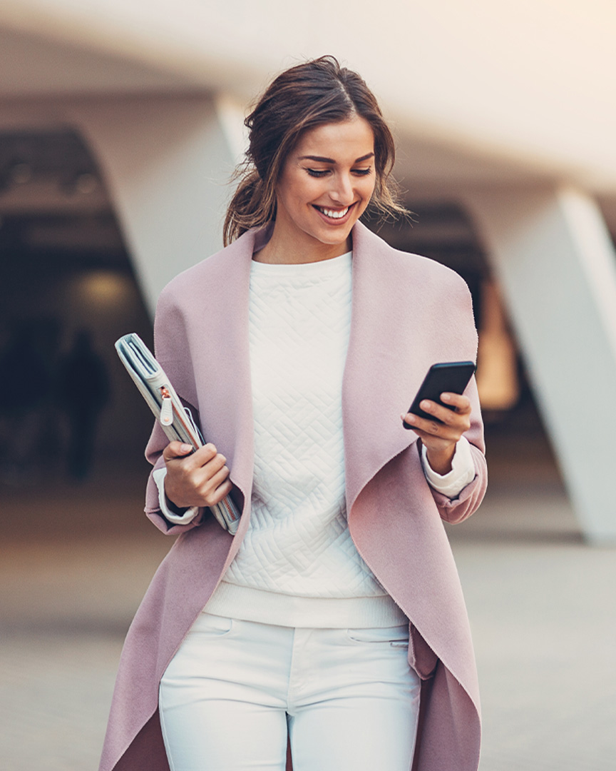 An international business owner checking their online account on a mobile phone.