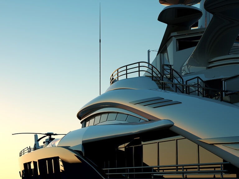 The front of a luxurious yacht with a helicopter on the ocean.