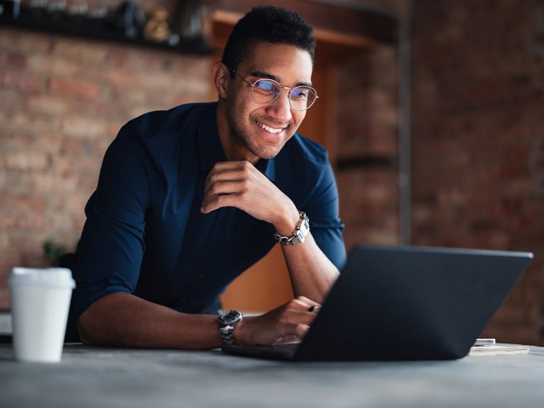 a person on their laptop smiling