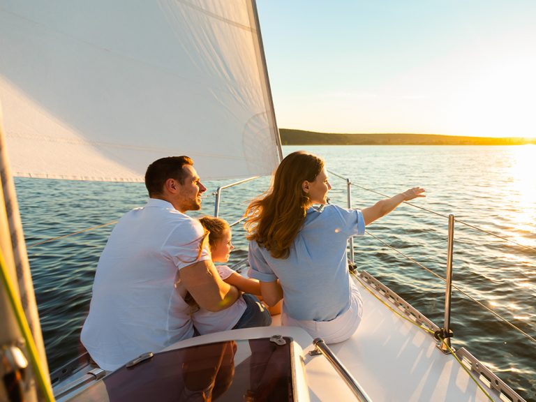 a family enjoying the sunset on a boat