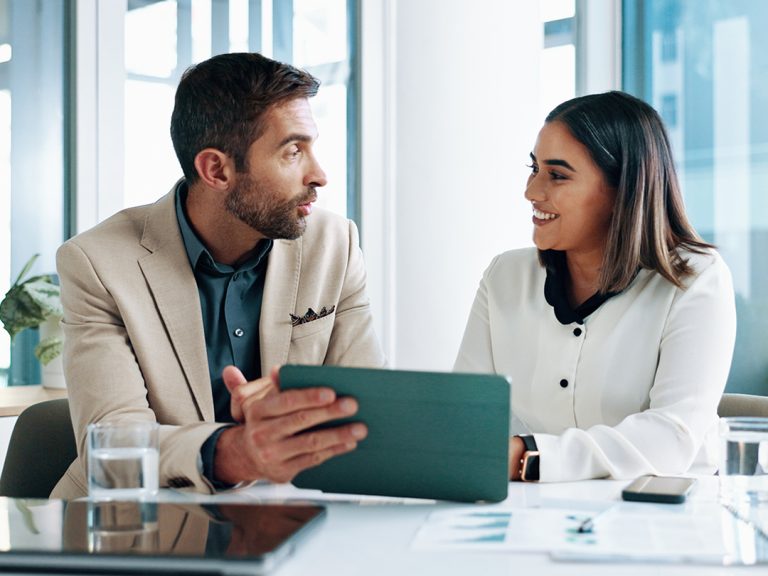 a couple reviewing investments on a tablet