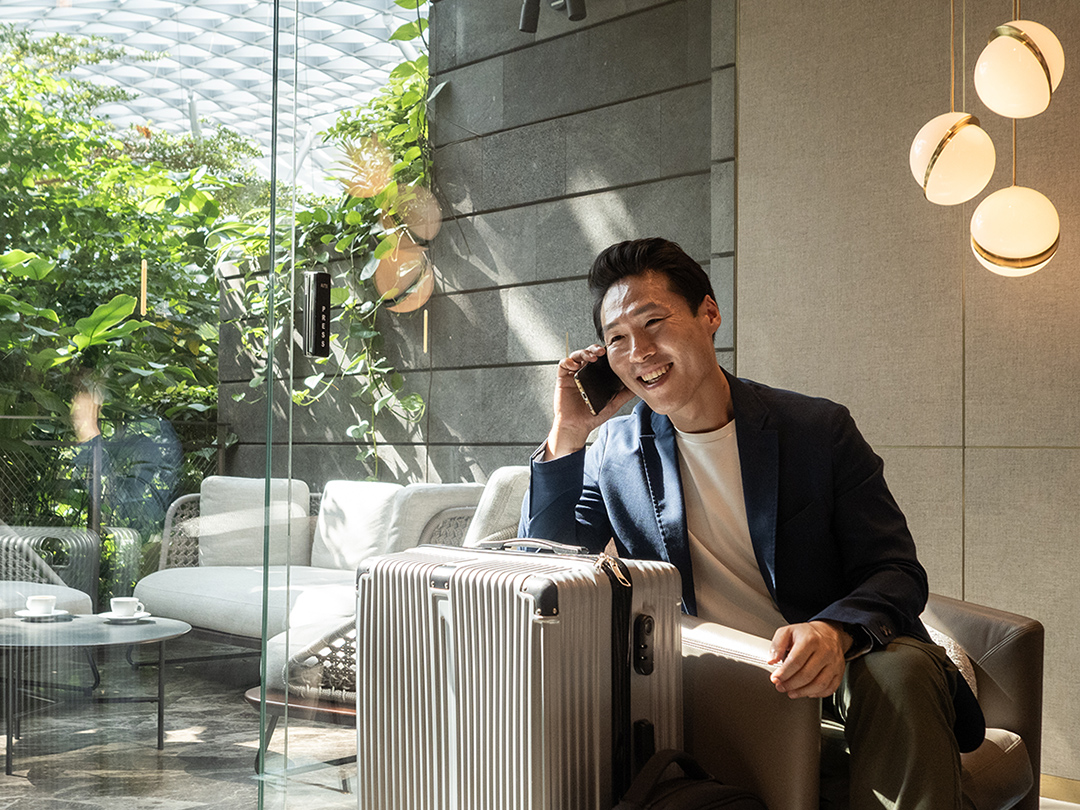 a person on the phone talking to someone while sitting